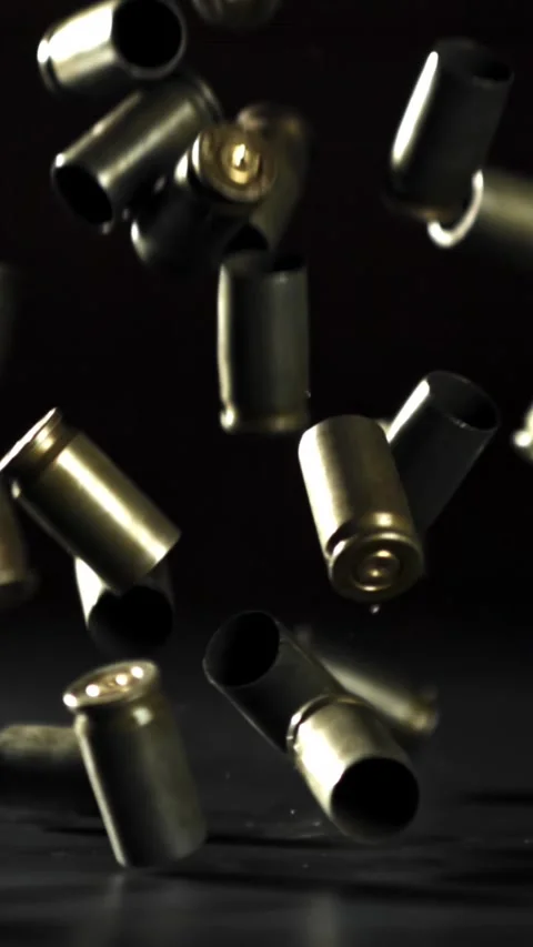 Bullet casings are pressed on the table. Filmed on a high-speed camera at 1000 Stock Footage 335368781
