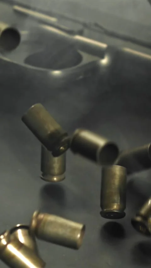Bullet casings are pressed on the table. Filmed on a high-speed camera at 1000 Stock Footage 335370960