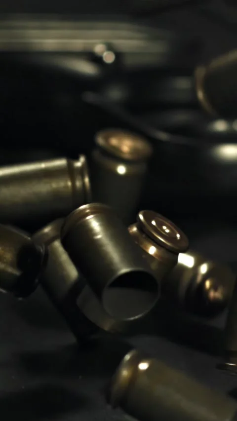 Bullet casings are pressed on the table. Filmed on a high-speed camera at 1000 Stock Footage 335371590