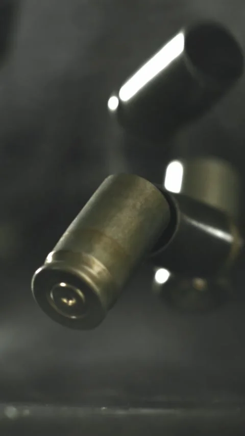 Bullet casings are pressed on the table. Filmed on a high-speed camera at 1000 Stock Footage 335372226