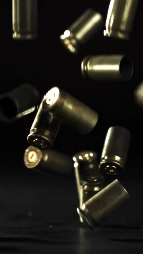 Bullet casings are pressed on the table. Filmed on a high-speed camera at 1000 Stock Footage 335373752