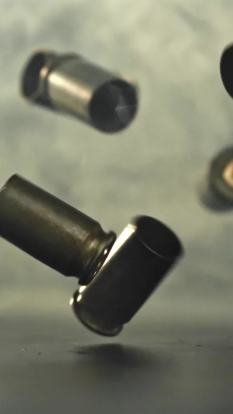 Bullet casings are pressed on the table. Filmed on a high-speed camera at 1000 Stock Footage 335380101