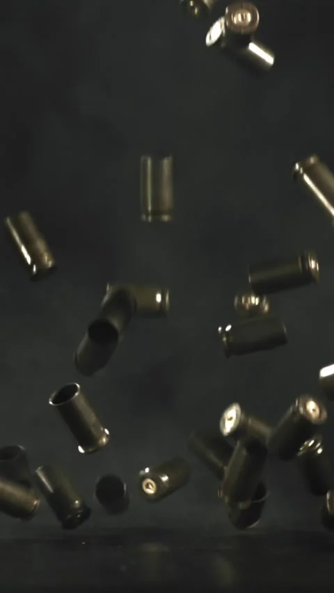 Bullet casings are pressed on the table. Filmed on a high-speed camera at 1000 Stock Footage 335382363