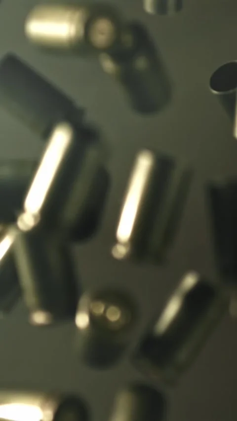 Bullet casings fly up and fall. Filmed on a high-speed camera at 1000 fps Stock Footage 335373936