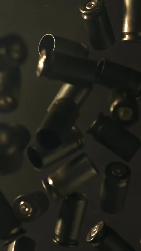 Bullet casings fly up and fall. Filmed on a high-speed camera at 1000 fps Stock Footage 335376986