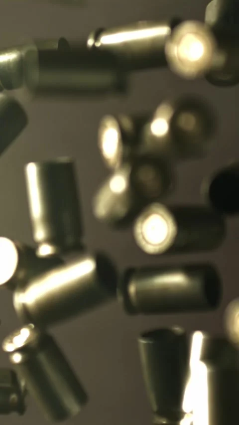 Bullet casings fly up and fall. Filmed on a high-speed camera at 1000 fps Stock Footage 335384435