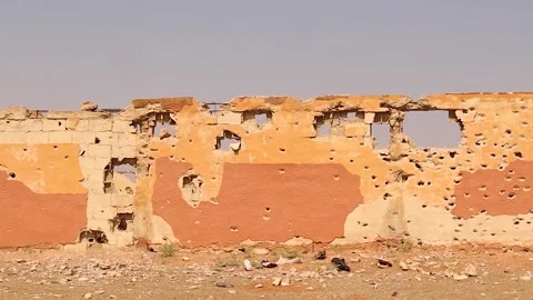 Bullet-damaged wall facing Aleppo Central Prison after the end of Syrian war Stock Footage 312724257