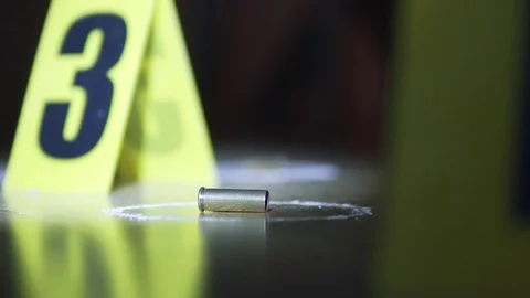 Bullet next to markers at crime scene Stock Footage 110714015