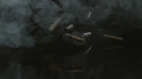 Bullet shells and smoke falling in slow motion; shot on Phantom Flex 4K at 1000 Stock Footage