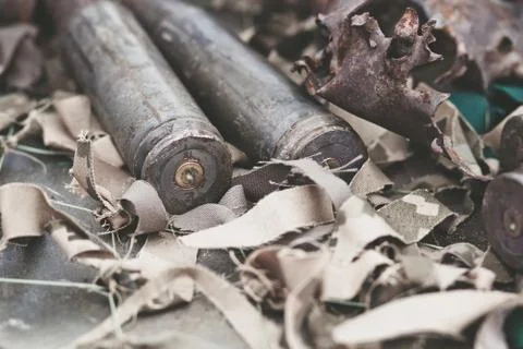 Bullet shells from heavy machine gun on the table with camouflage netting Photos
