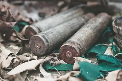 Bullet shells from heavy machine gun on the table with camouflage netting Stock Photos