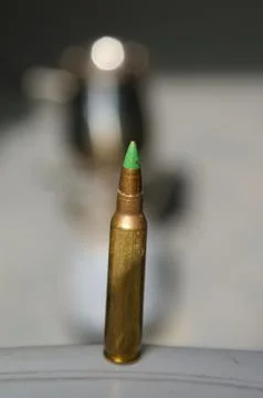 A bullet on a table Stock Photos