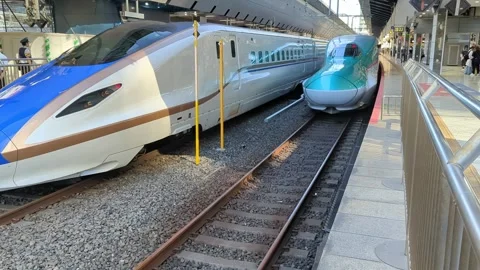A bullet train or shinkansen pulling out of Tokyo Station Stock Footage 247500679