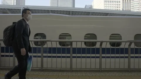 Bullet train passes by at train station Stock Footage 230537390