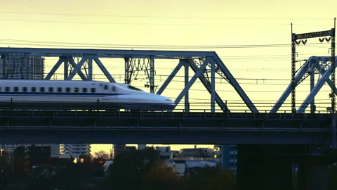 The bullet train Shinkansen Passing on bridge during golden hour Stock-Footage 228662119
