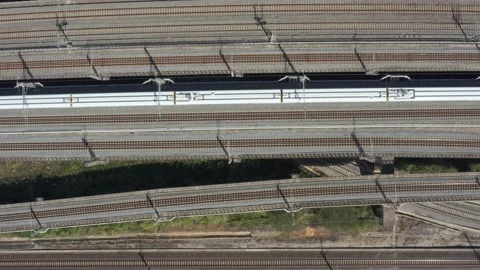Bullet train slowly passes through dense railway tracks Stock Footage 234733679