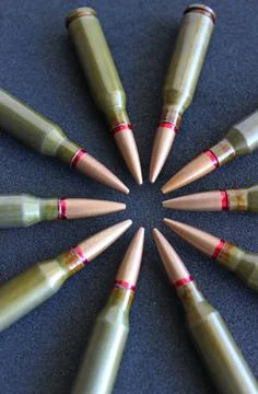 Bullets In Aim Shape On Black Surface Closeup View Stock Photos
