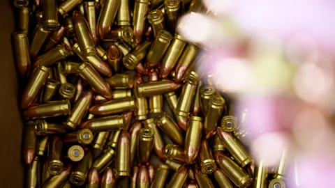 Bullets are falling from the persons hand to the box with ammunition. Close up Stock Footage 334021439