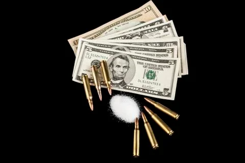 Bullets on dollars Stock Photos