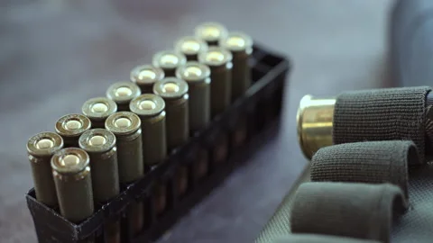 Bullets in packaging on the table. | Stock Video | Pond5