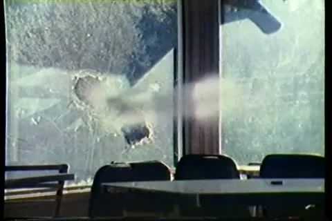 Bullets shattering window Stock Footage 11354379