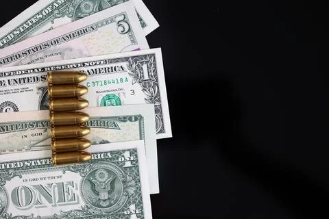 Bullets on US Dollar Banknotes with Copy Space Stock Photos