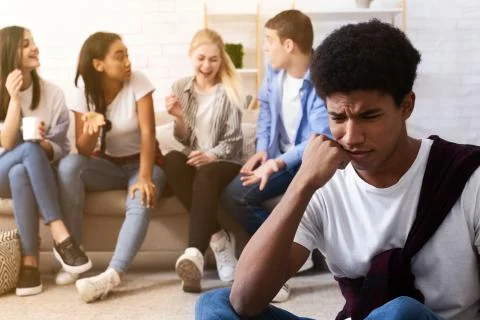 Bullying concept. Sad guy avoiding bad friends Stock Photos