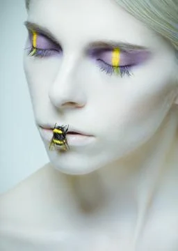 Bumblebee: model with creative make-up and bug on her lips Photos