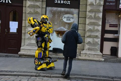 Bumblebee's robot from transformers and iron man, entertains children on an a Stock Photos