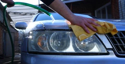 Bumper and headlight of the car in the process of manual washing Stock Photos