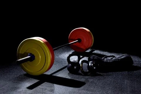 Bumper plates in gym with dramatic lighting Stock Photos