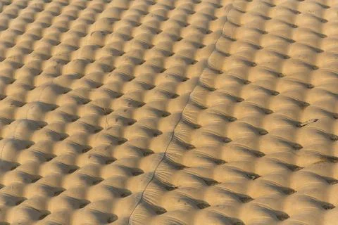 Bumpy concrete channel lining texture under beautiful golden light Stock Photos