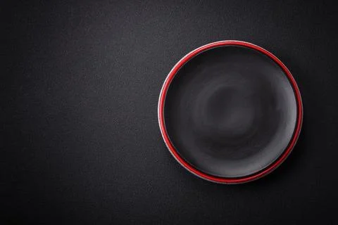 Bumpy empty ceramic plate on a textured concrete background 写真素材