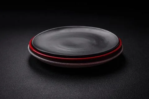 Bumpy empty ceramic plate on a textured concrete background 写真素材