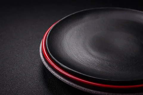 Bumpy empty ceramic plate on a textured concrete background Stock Photos