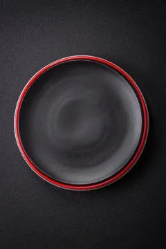 Bumpy empty ceramic plate on a textured concrete background Stock Photos