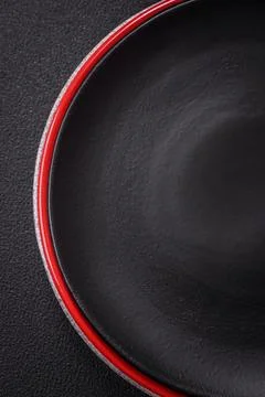 Bumpy empty ceramic plate on a textured concrete background 스톡 사진