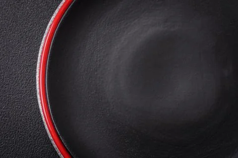 Bumpy empty ceramic plate on a textured concrete background Stock Photos