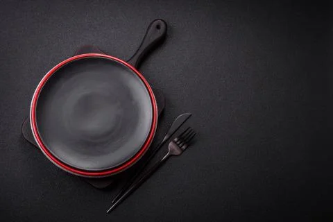 Bumpy empty ceramic plate on a textured concrete background 写真素材