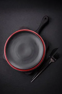 Bumpy empty ceramic plate on a textured concrete background Stock Photos