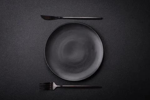 Bumpy empty ceramic plate on a textured concrete background Stock Photos