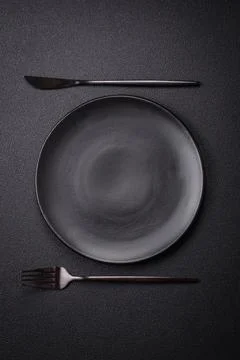 Bumpy empty ceramic plate on a textured concrete background Stock Photos