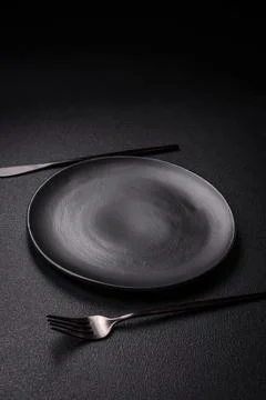 Bumpy empty ceramic plate on a textured concrete background 스톡 사진