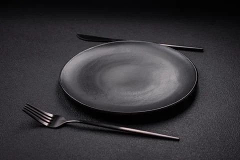 Bumpy empty ceramic plate on a textured concrete background Stock Photos