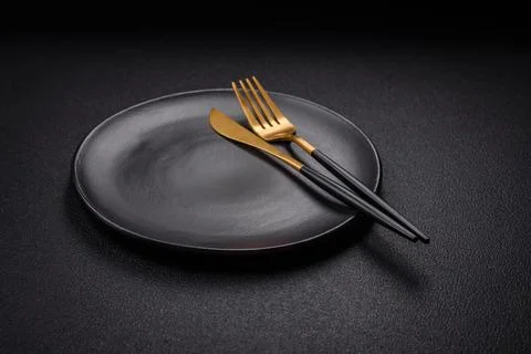 Bumpy empty ceramic plate on a textured concrete background 스톡 사진