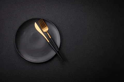 Bumpy empty ceramic plate on a textured concrete background 스톡 사진