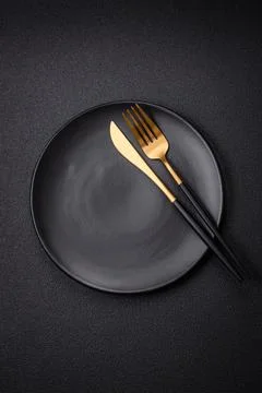 Bumpy empty ceramic plate on a textured concrete background 写真素材