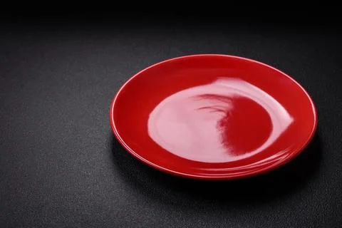 Bumpy empty ceramic plate on a textured concrete background 写真素材