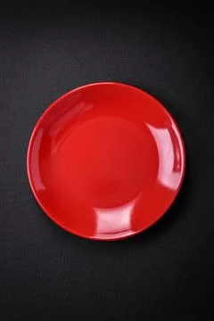 Bumpy empty ceramic plate on a textured concrete background 스톡 사진