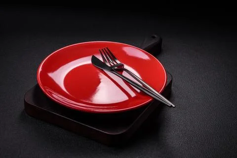 Bumpy empty ceramic plate on a textured concrete background Stock Photos